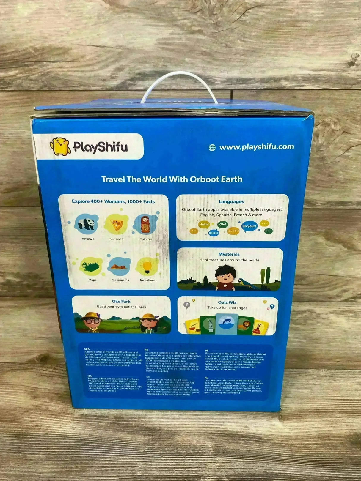 Back view of PlayShifu Orboot Earth box showing educational features and app languages on a wood background