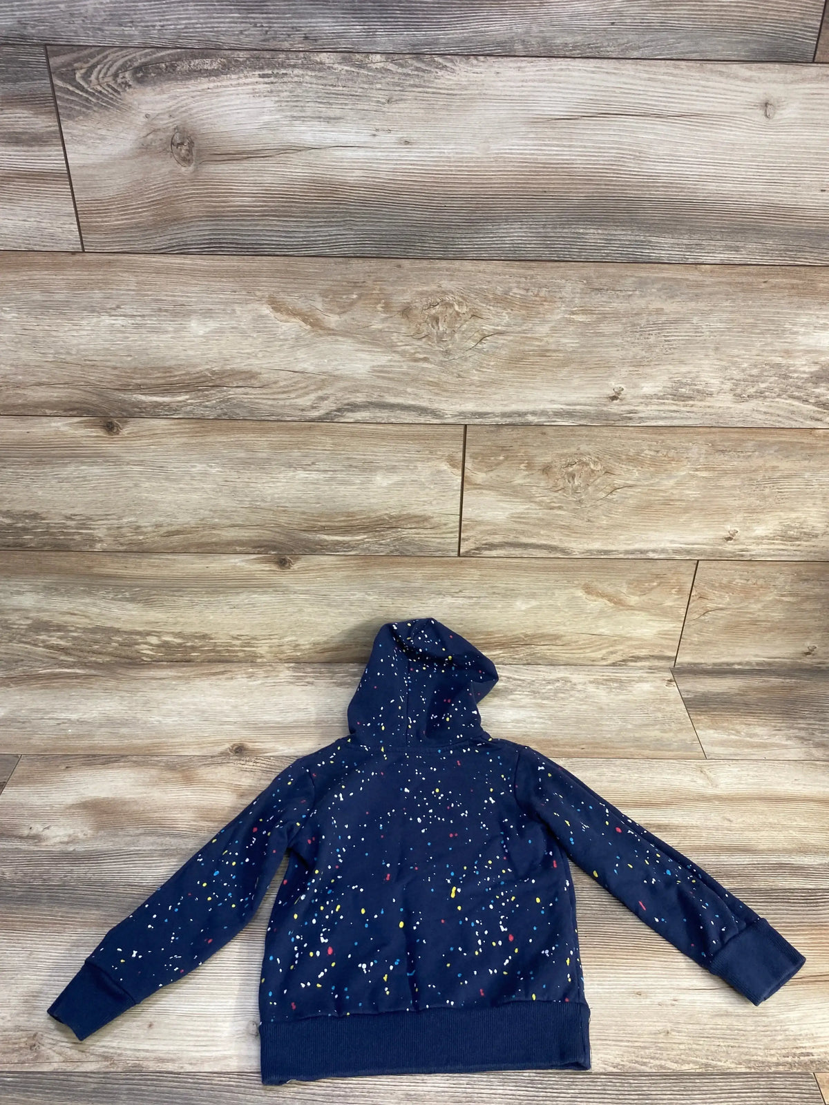 Back view of navy Sonic the Hedgehog hoodie showcasing attached hood, long sleeves, and multicolored confetti speckle print