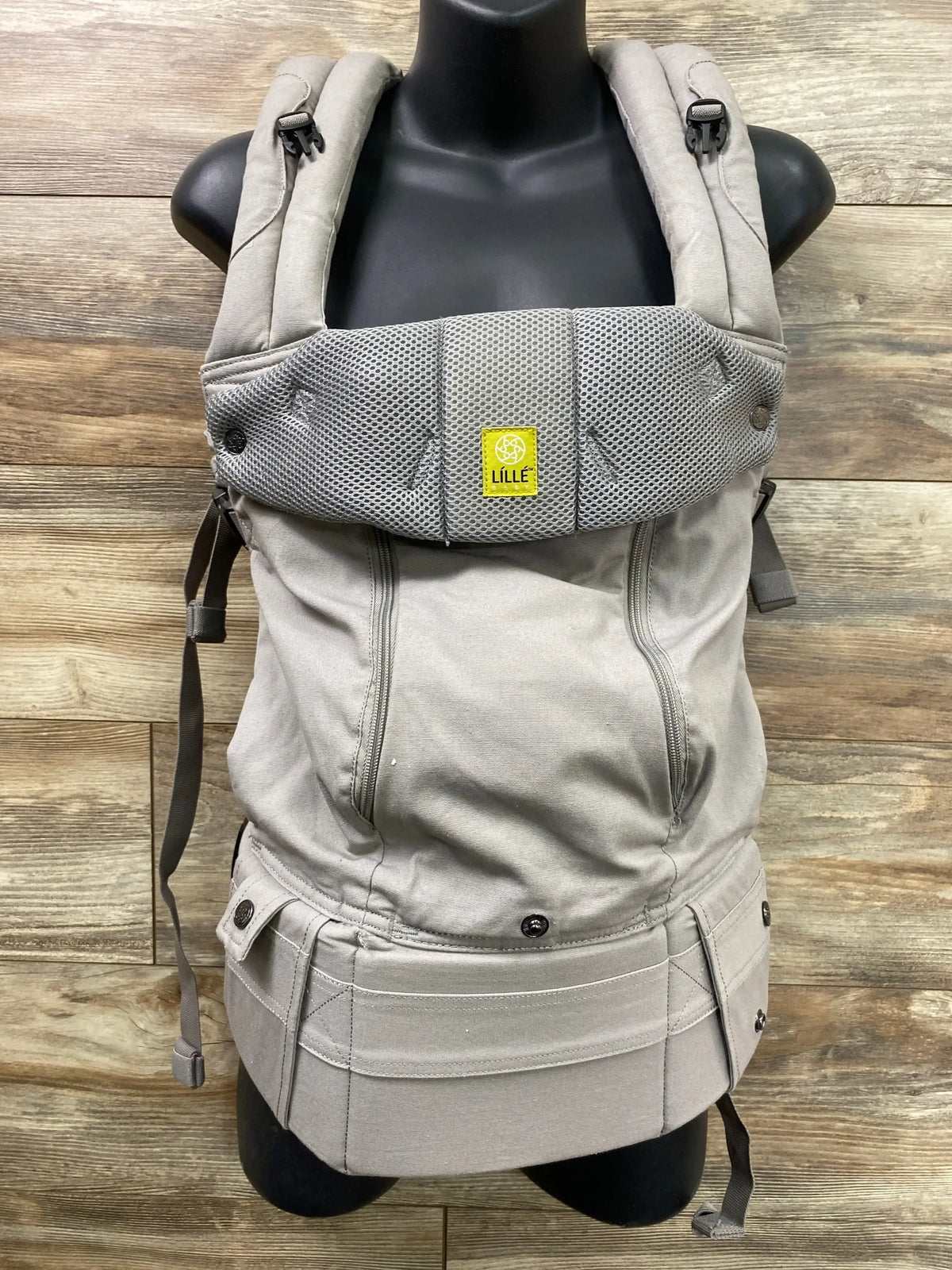 Front view of Lille Baby Complete 6-in-1 carrier in stone grey showing padded straps, mesh panel and waist belt