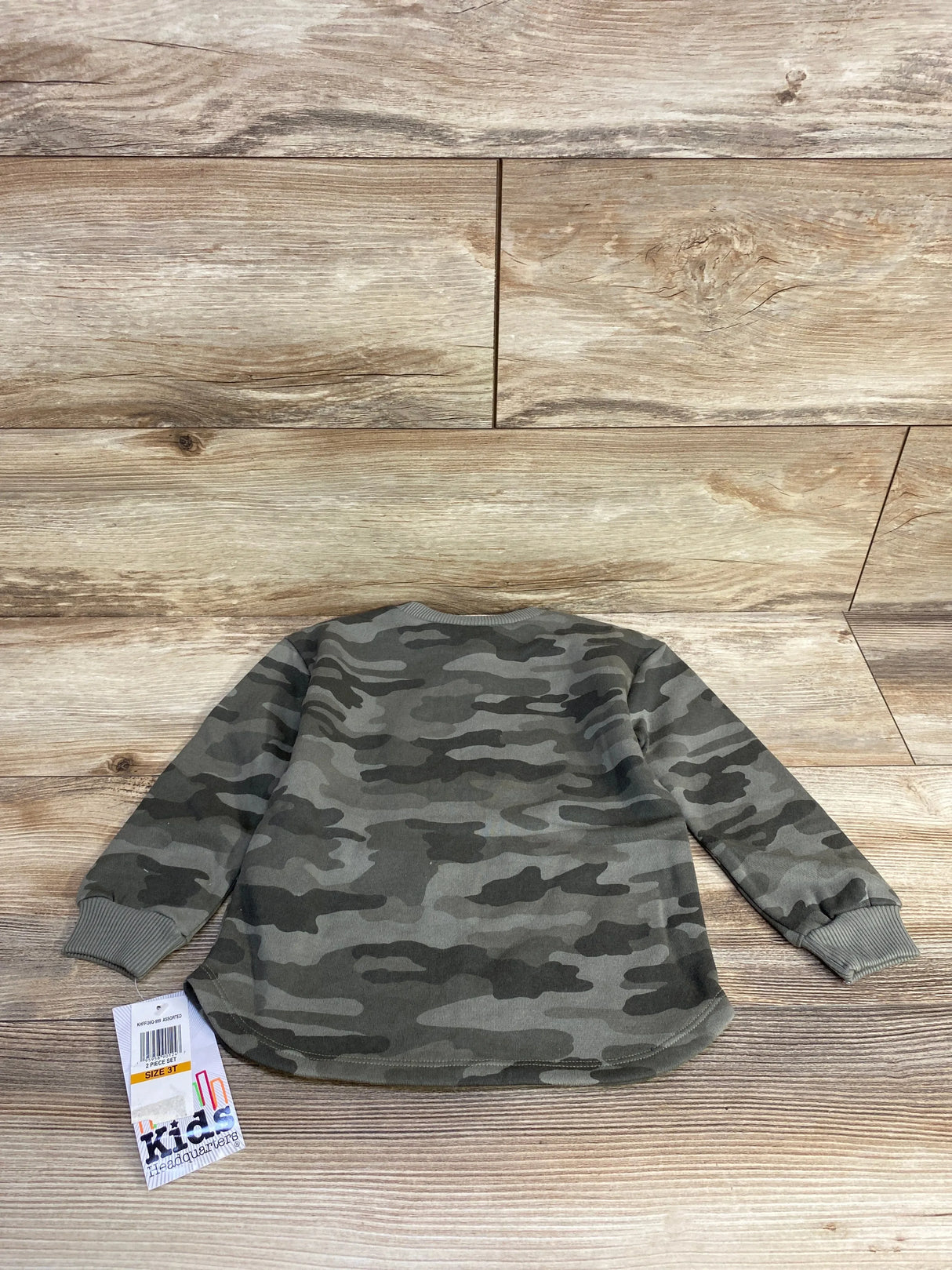Kids camo print long-sleeve sweatshirt in size 3T on wooden floor with Kids Headquarters tag