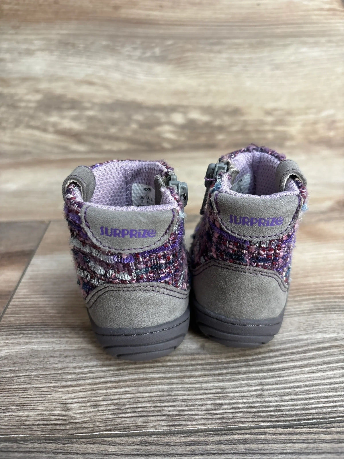 Pair of Surprize toddler boots with purple knit fabric, gray suede heels on wood floor