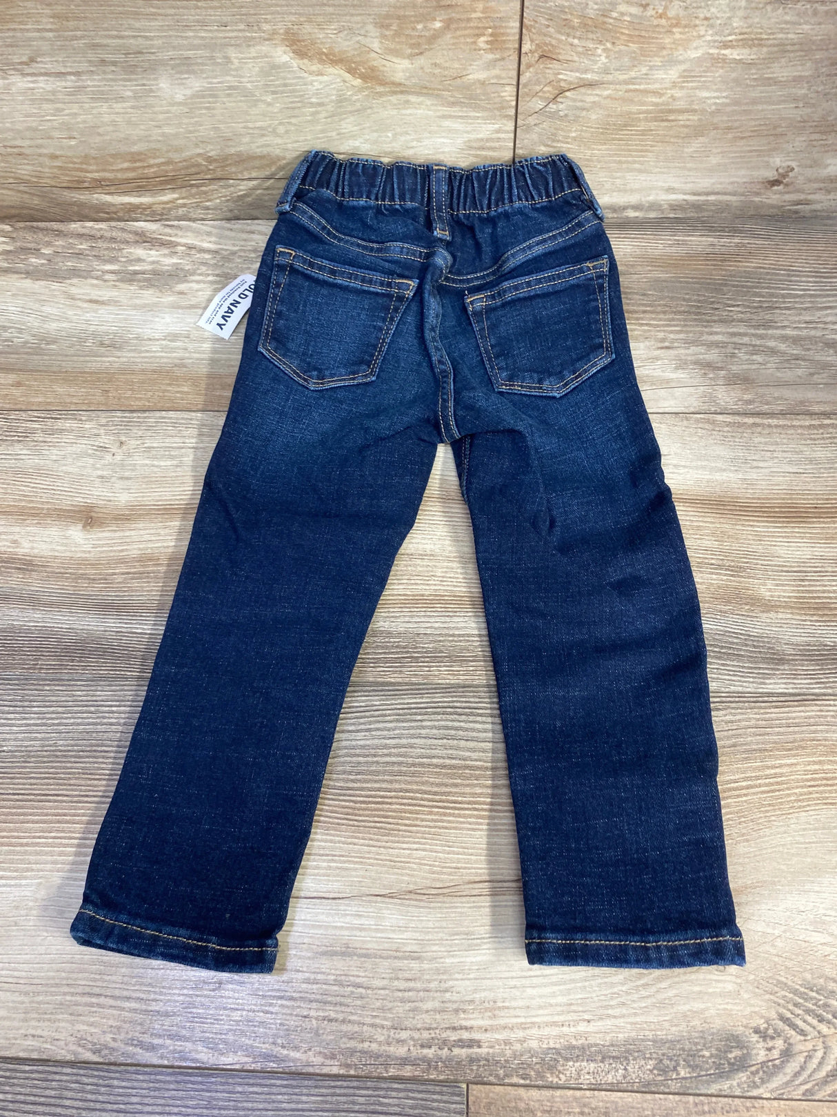 Back view of NEW Old Navy 360 Stretch skinny jeans size 2T showing elastic waistband and two back pockets on wood floor