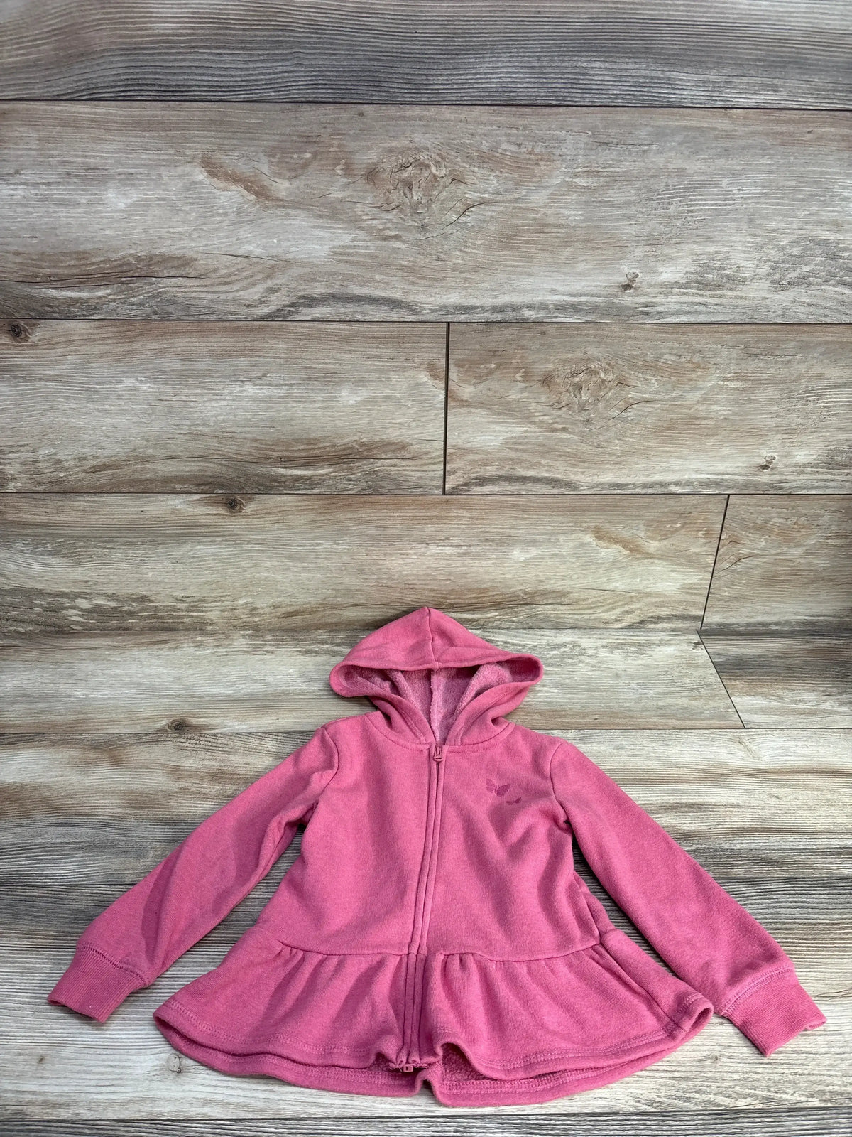 pink hooded fleece jacket for children with zipper and peplum hem on wooden floor