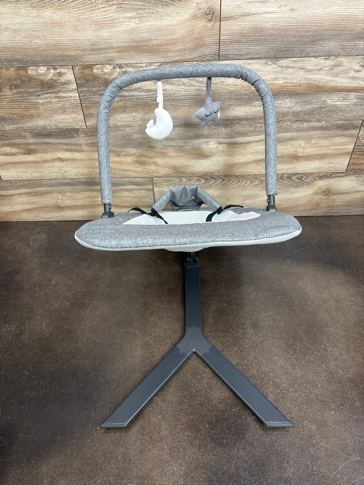 Front of Baby Delight Alpine Deluxe bouncer in charcoal grey with toy bar (moon and star plushes) and padded mesh seat