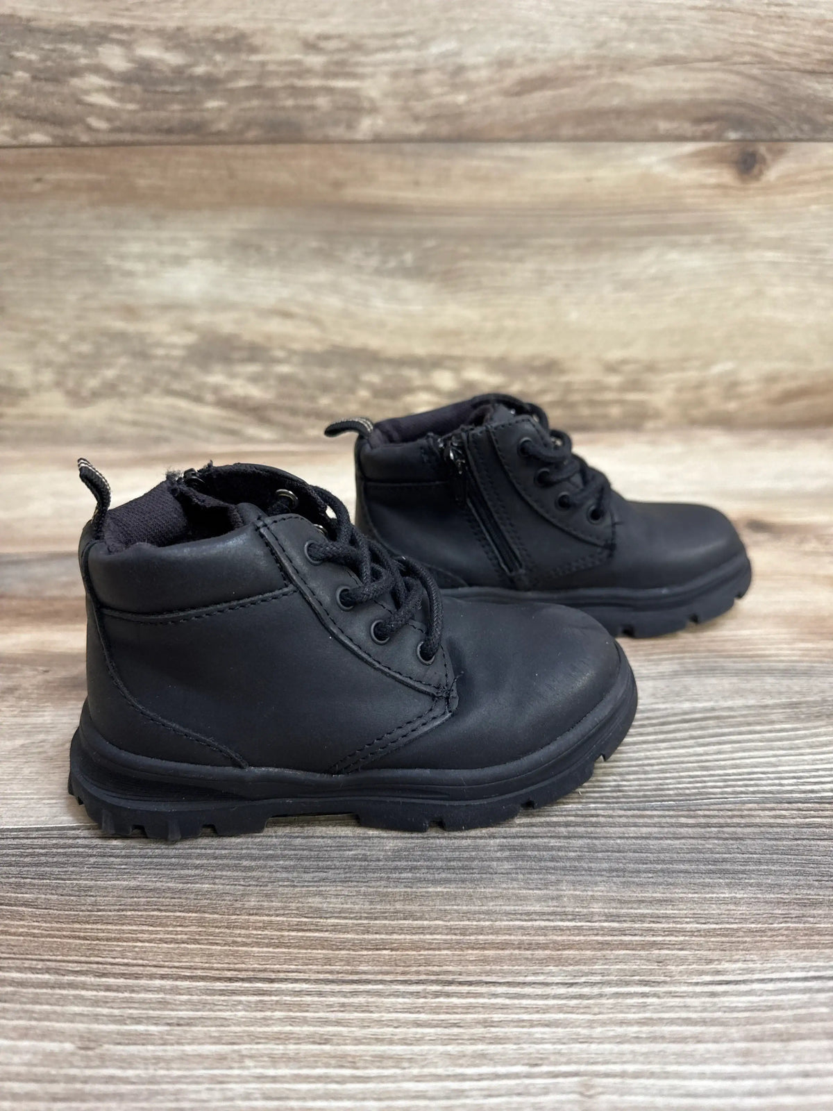 Side view of Zara toddler side-zip boots size 7C showing side zipper and textured faux-leather upper on white background