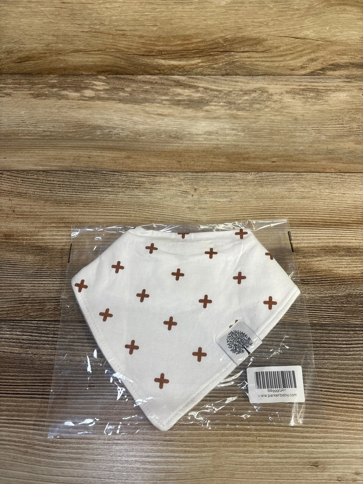 New white Me n Mommy To Be bandana bib with brown cross pattern in clear packaging