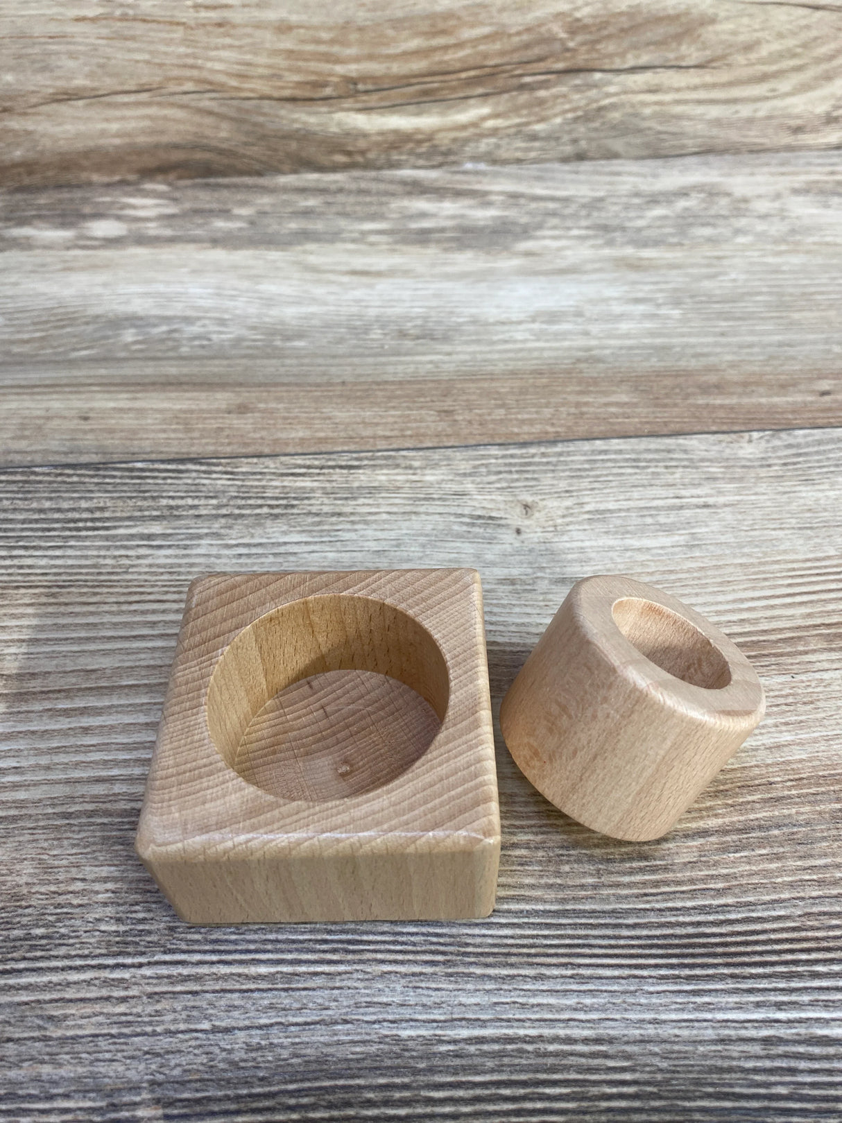 Wooden Montessori cylinder block toy on rustic wood background