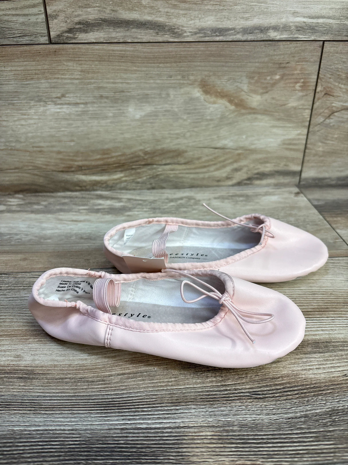Pink ballet flats with bows on wooden floor, Girls dance shoes, Ballet slippers