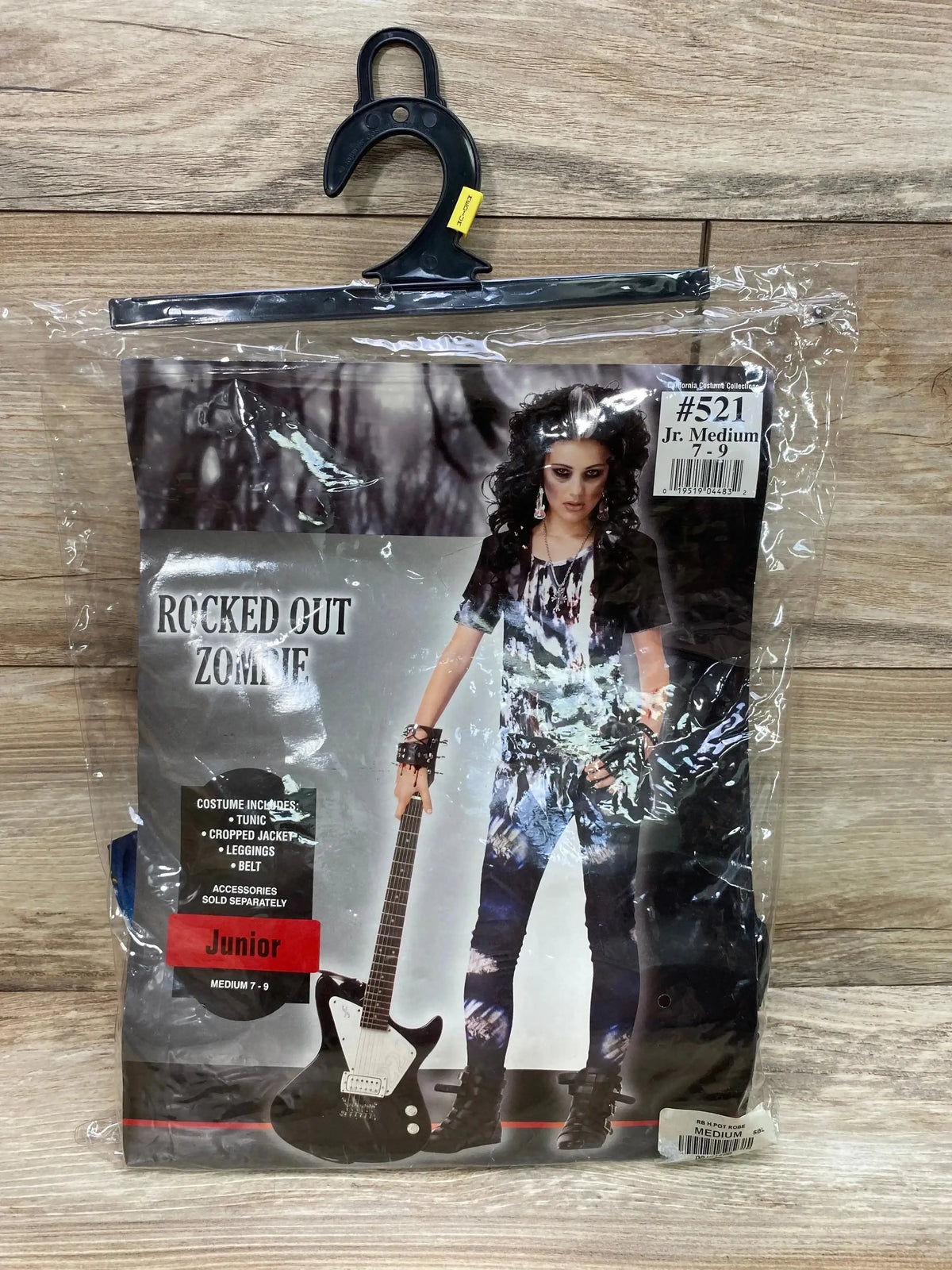 Front view of Rubie’s Rocked Out Zombie Girl costume package showing tunic, cropped jacket, leggings, and belt, size 7-9