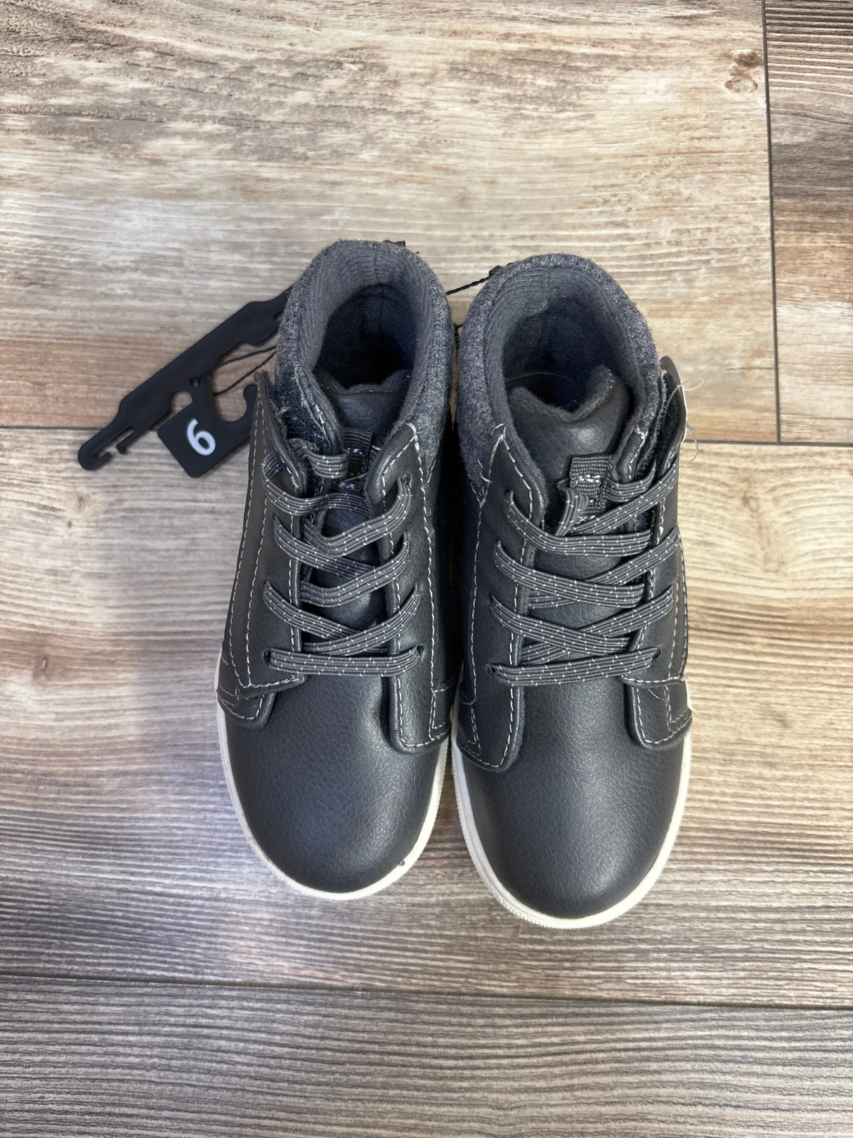 Top view of Wonder Nation grey high-top toddler sneakers showcasing lace-up front and padded ankle collar on wood floor