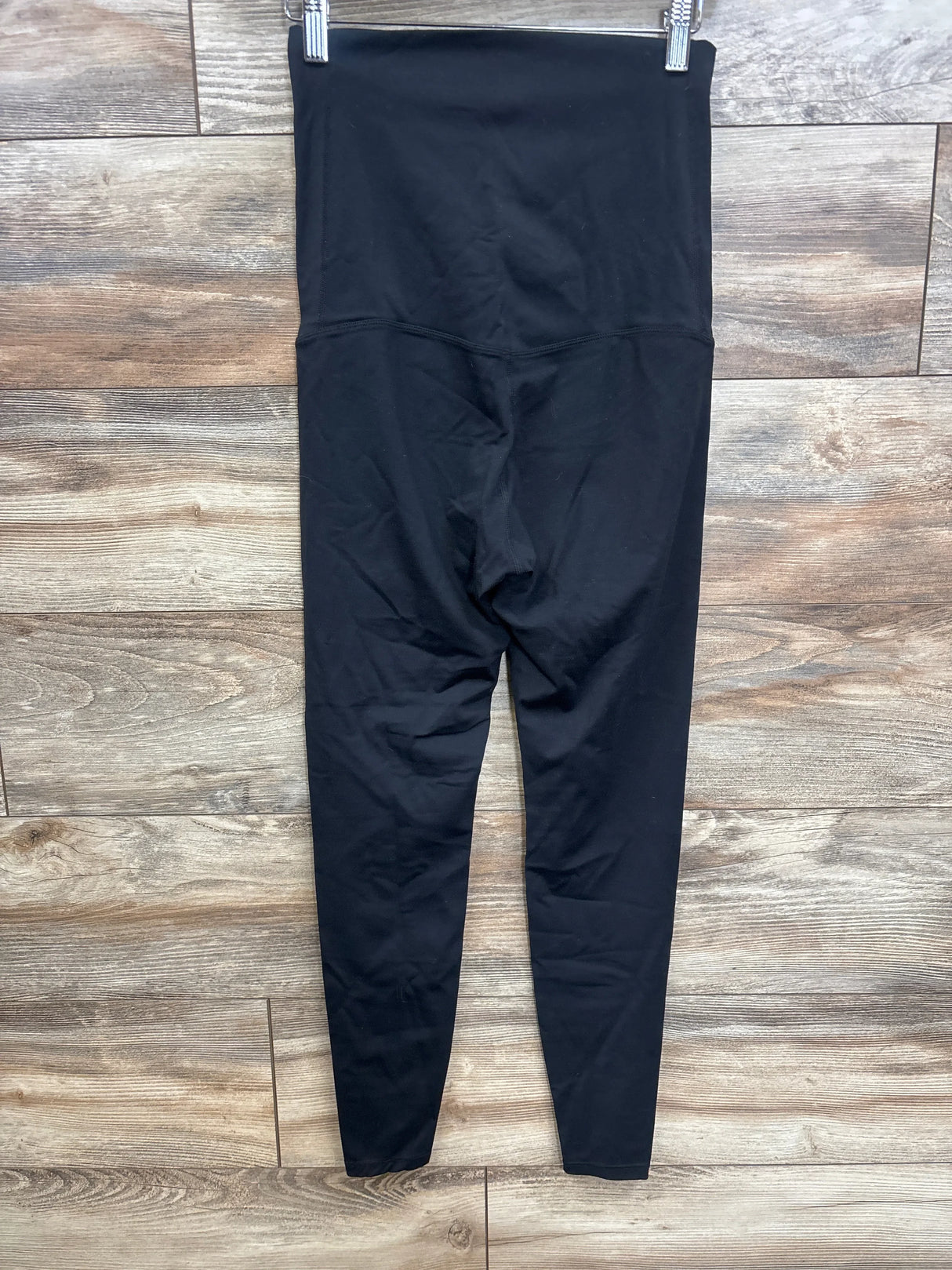 Front view of Poshdivah full panel leggings in black, size XS, showcasing the full-panel waistband on a wood floor