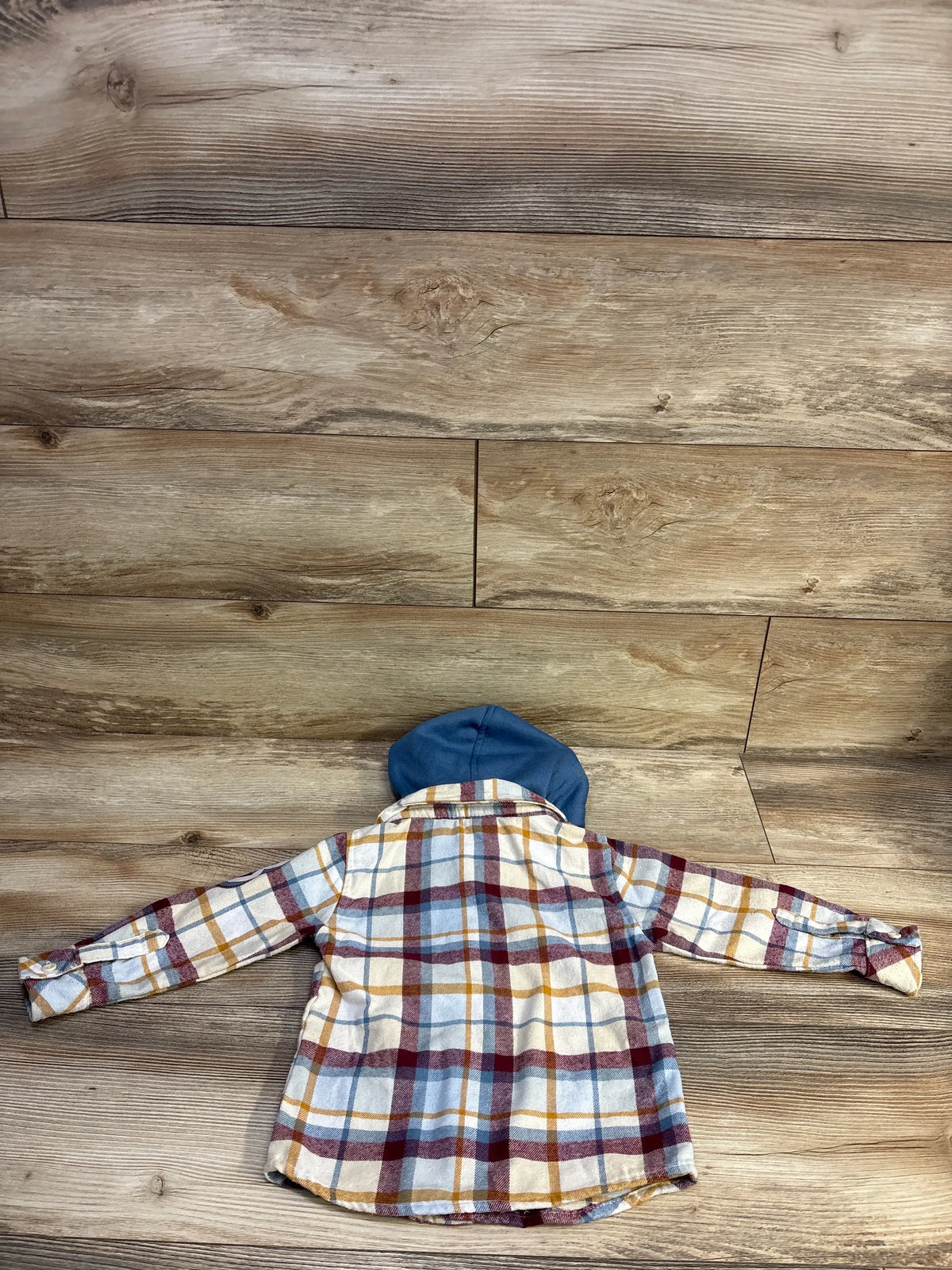 Back view of Mini Fresh hooded flannel showcasing a blue hood and plaid pattern on a wood floor