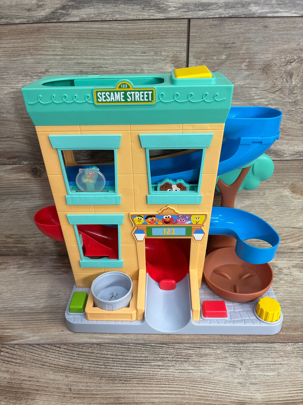 Sesame Street playset building with character stickers and colorful chutes for kids
