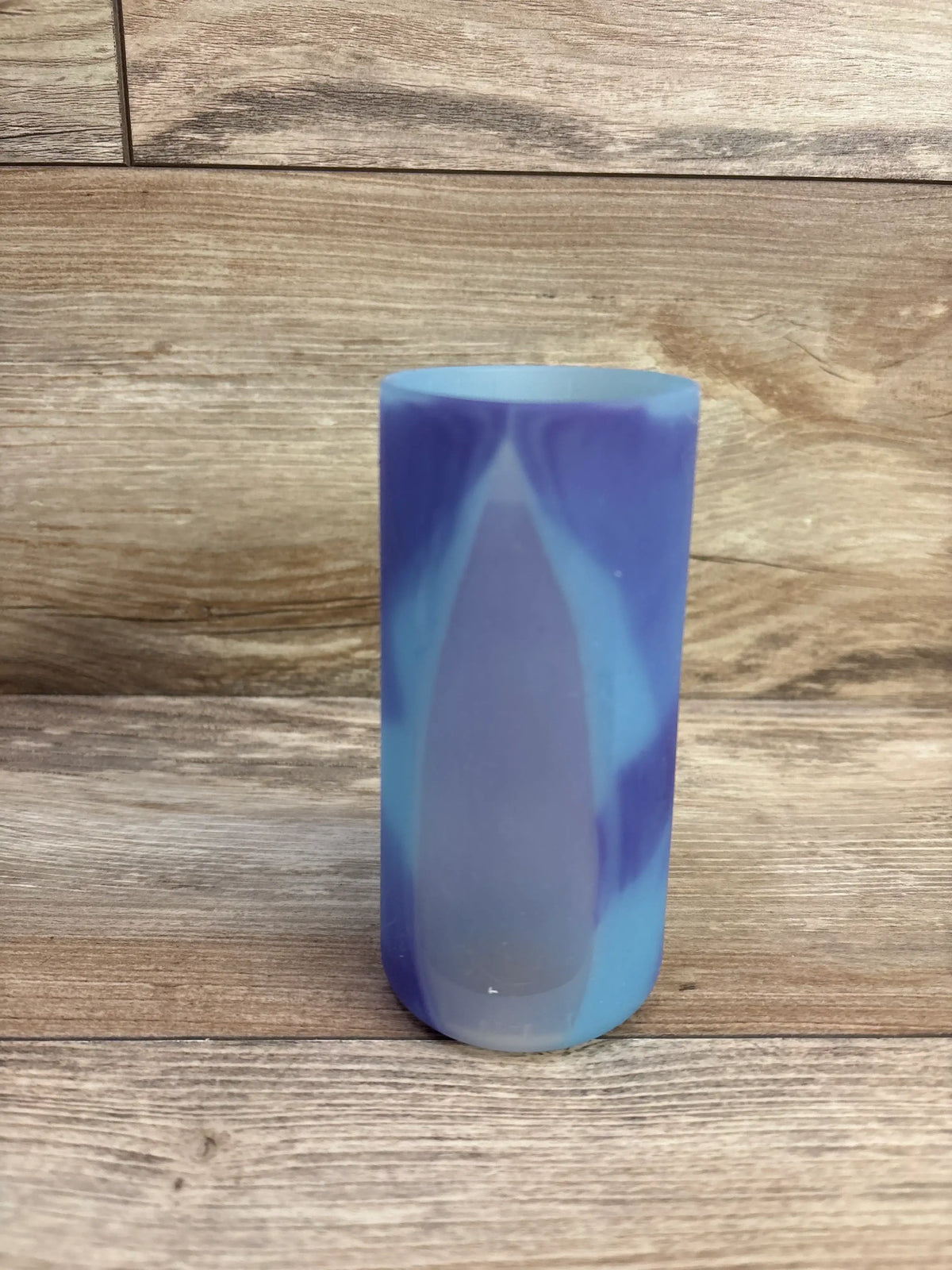 Front view of Dr Brown's narrow 8oz silicone bottle sleeve showing blue and purple marbled pattern on wood background