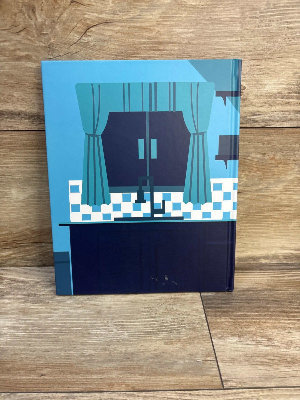 Back cover of Harold the Iceberg Melts Down Hardcover Book showing a blue kitchen window scene on a wood background