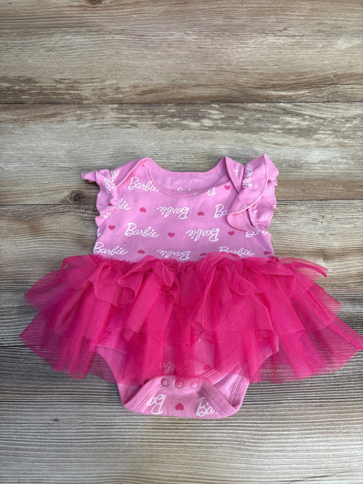 Pink Barbie baby onesie with ruffle sleeves and tulle skirt, perfect for infant girls' outfits