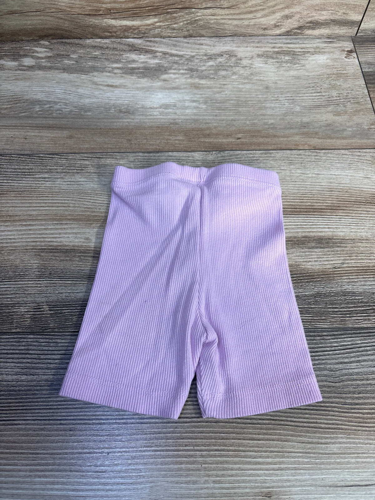 Cat & Jack ribbed bike shorts in pink for size 12m on a wooden background