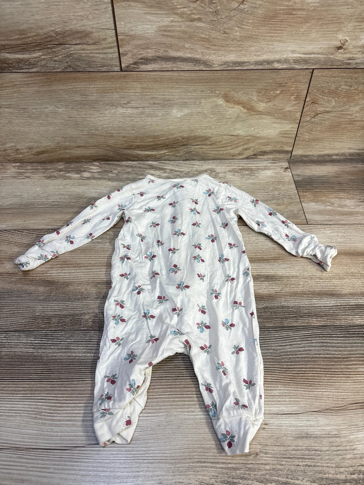 Flat view of beige Modern Moments floral viscose sleeper showcasing long sleeves and floral print on a wood floor