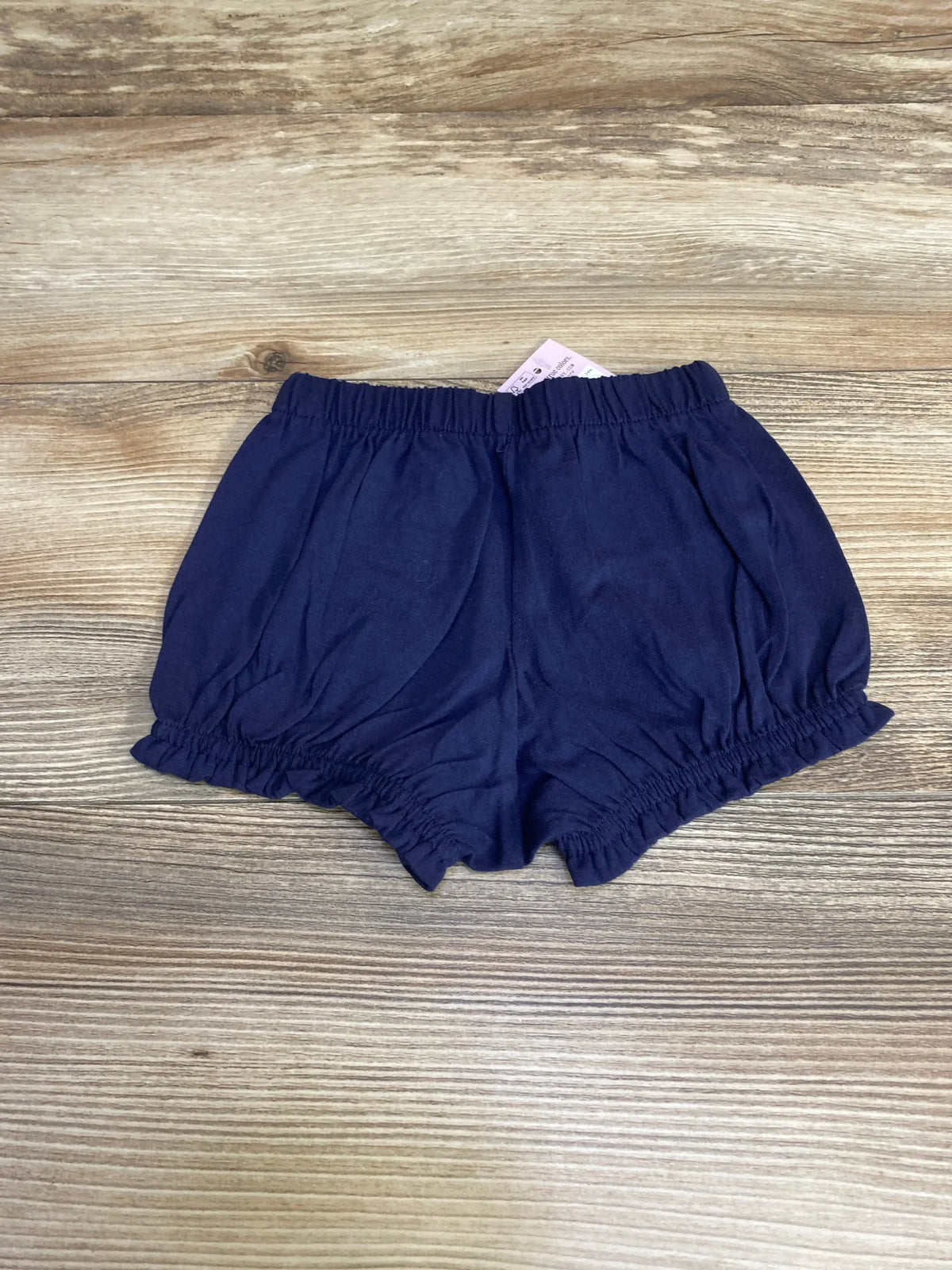 Front view of navy baby bloomer 3-6 months showcasing elastic gathered waist and ruffled leg openings on white background