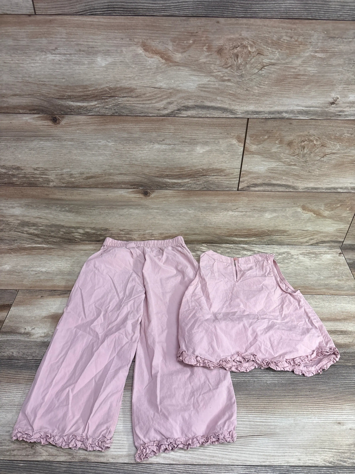 Zara 2pc pink sleeveless top and ruffle hem pants set for size 5T on a wooden background
