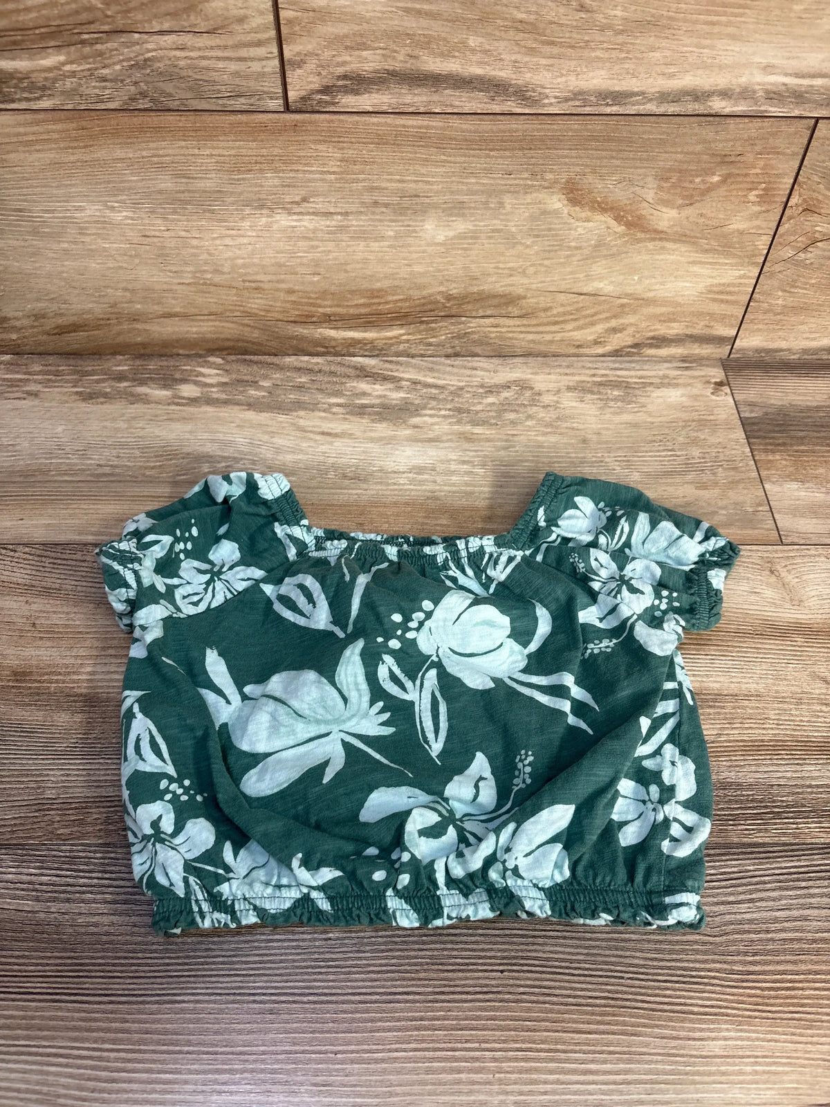 Carter's green floral cropped top for kids, size 5T, laid flat on a wooden surface.