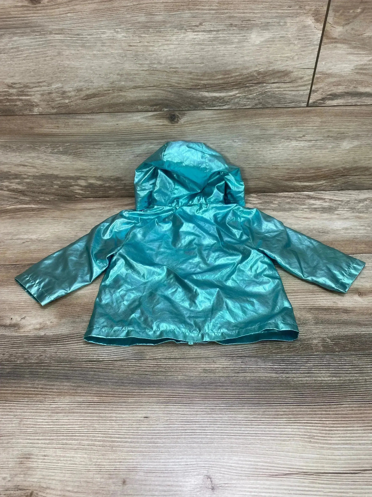 Back view of Wonder Nation baby windbreaker jacket in metallic teal with hood and long sleeves on wood background size 6-9 months