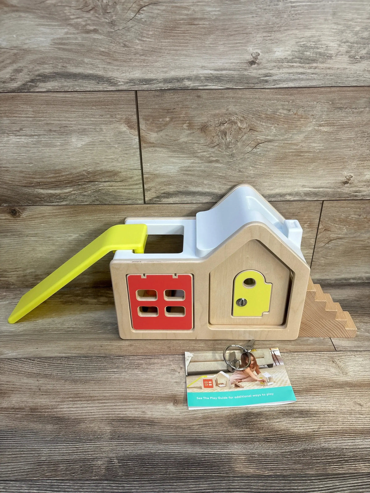 Wooden shape sorter toy house with colorful doors, slide, and keys for toddler learning and play