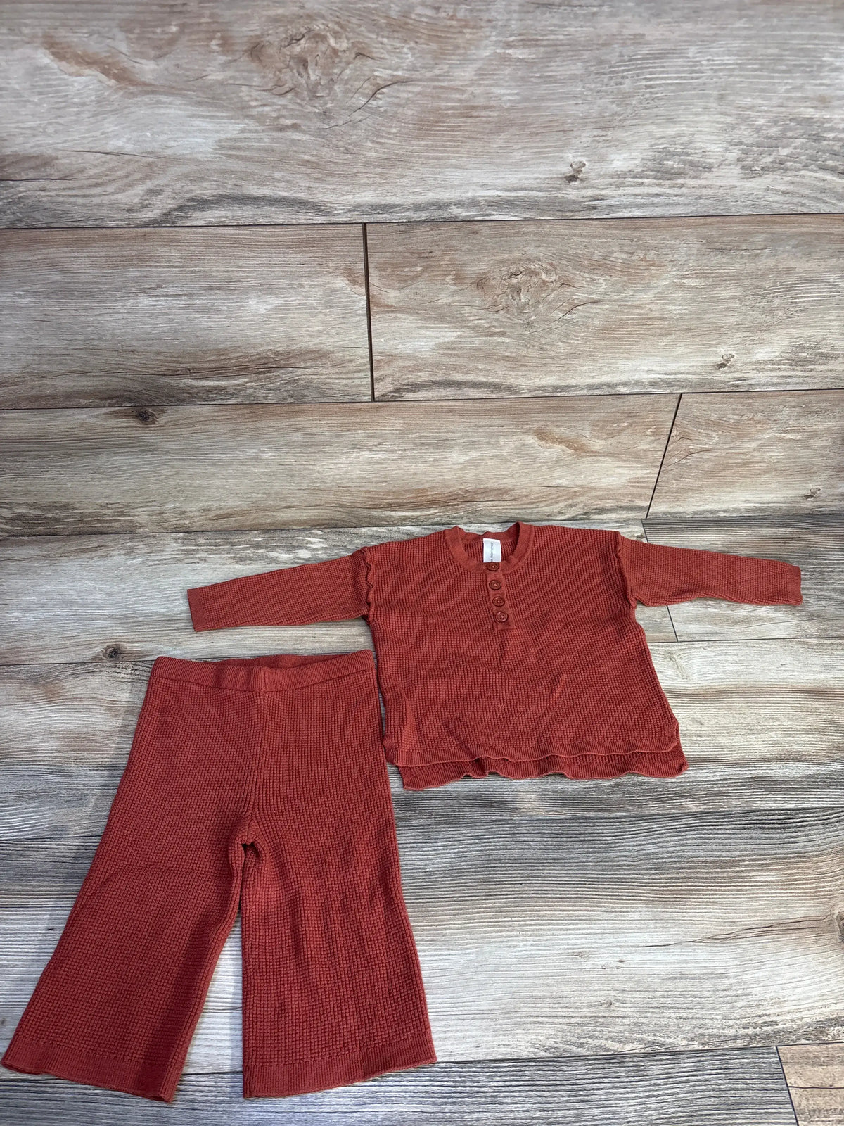 Flat lay of Modern Moments 2pc Waffle Knit Henley Shirt and Pants Set in rust, showcasing waffle knit texture and henley buttons