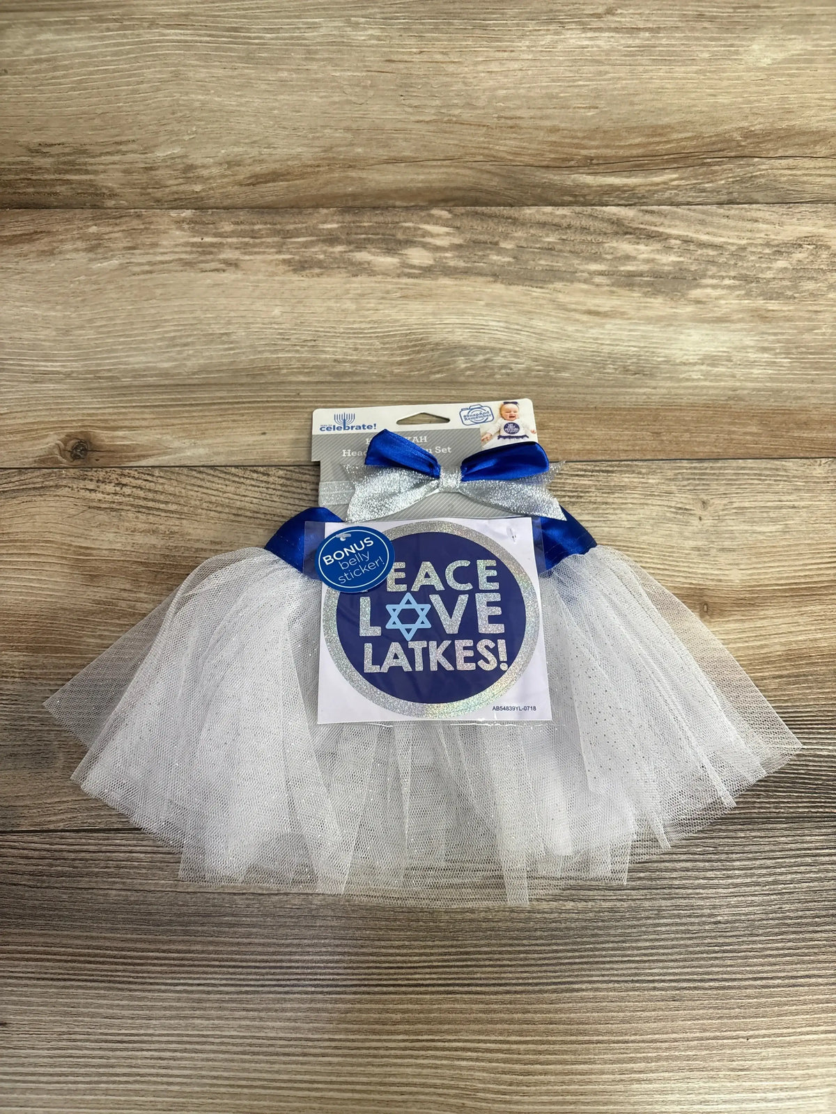 White tulle baby tutu with blue bow and 'Peace Love Latkes' sticker for Hanukkah celebration