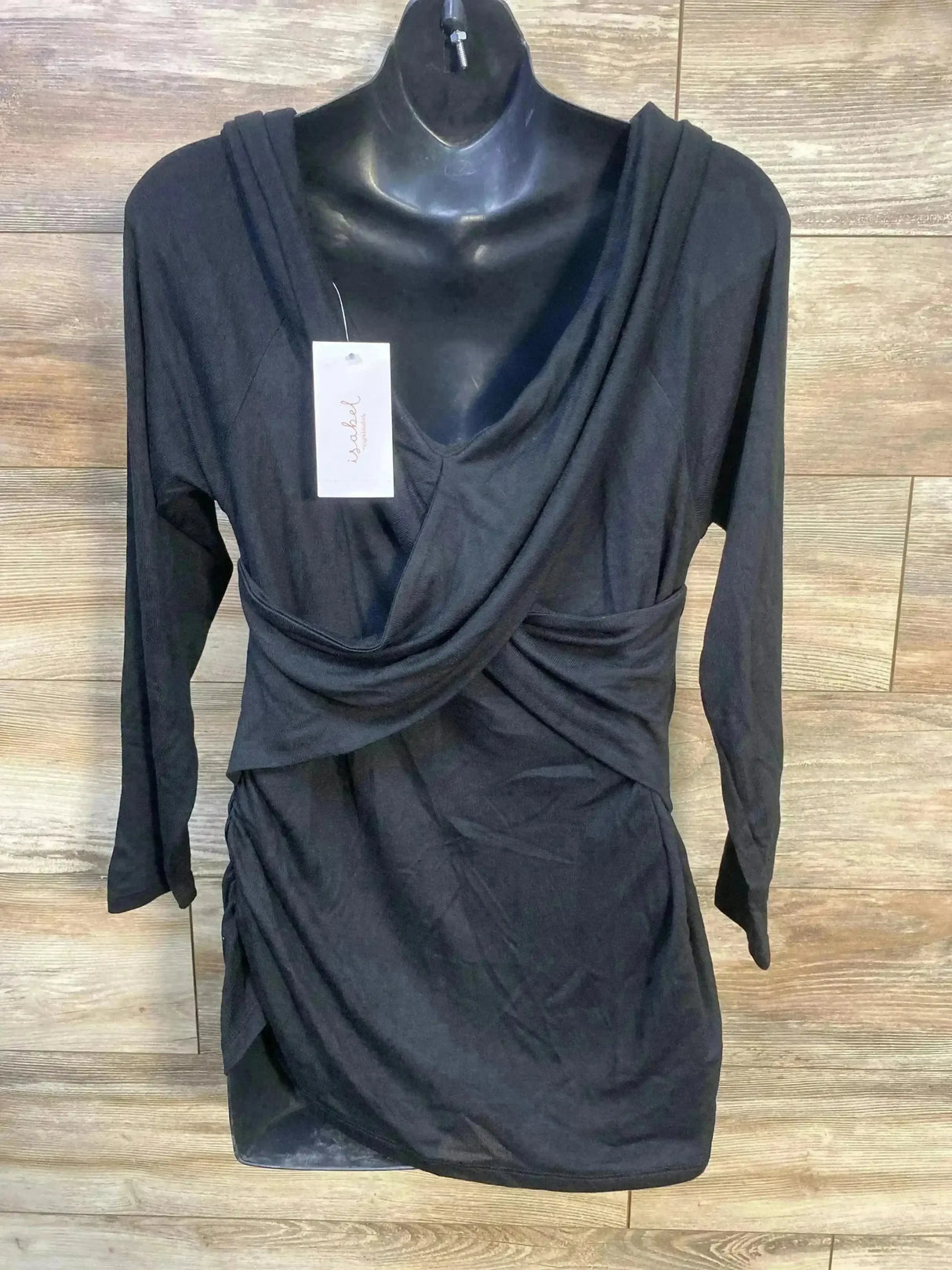 Front view of black Isabel maternity cross-front top with draped neckline and side ruching on mannequin