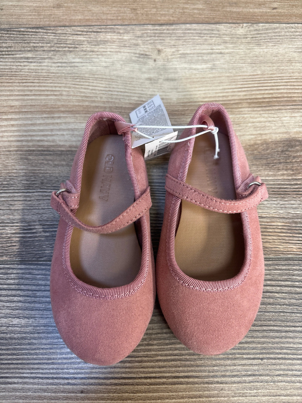 Pink toddler Mary Jane shoes with strap, Old Navy brand, displayed on wood surface