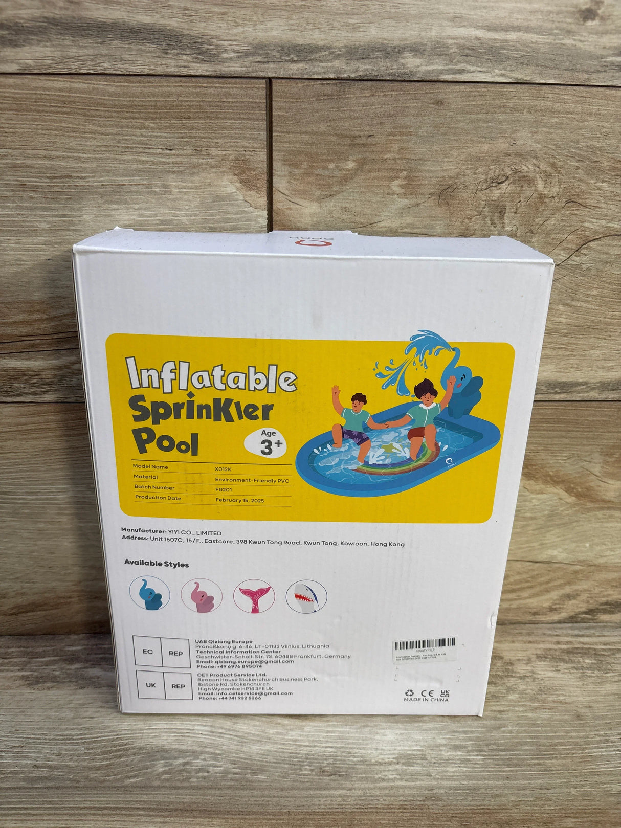 Front of box labeled Inflatable Sprinkler Pool showing pink elephant design with kids in blue pool, Ages 3 and up
