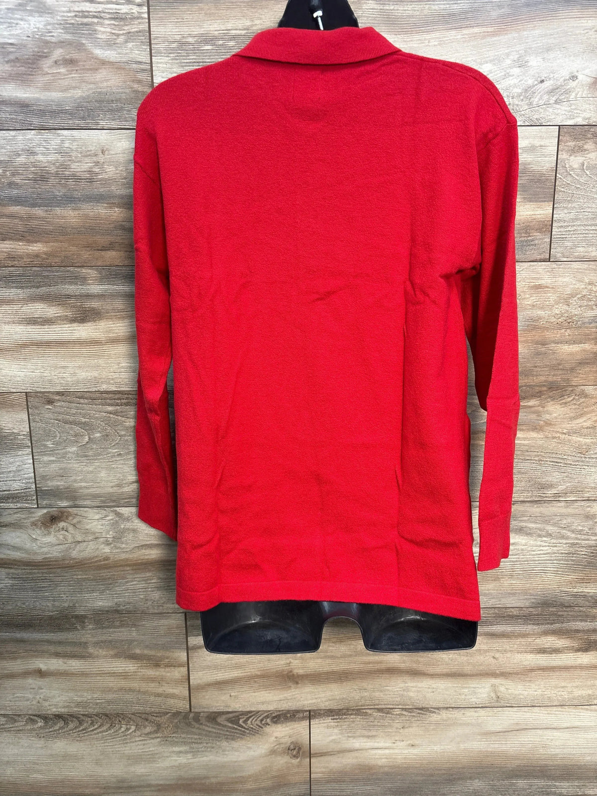 Back view of Gap CashSoft maternity polo sweater in red medium showing long sleeves and polo collar against wood panel background