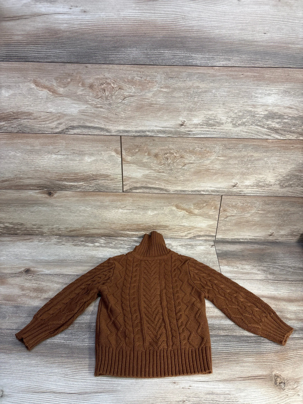 Front view of Shein brown cable knit turtleneck sweater size 5T showing cable knit pattern on wood flooring