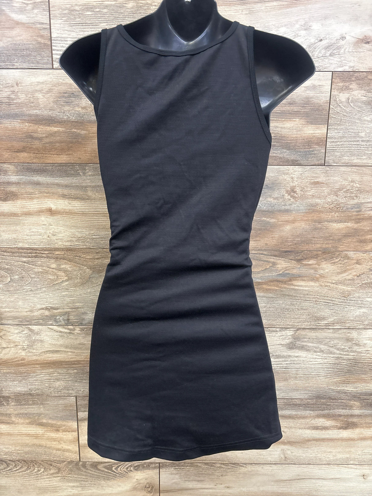 Black sleeveless maternity dress on mannequin, stylish and comfortable for pregnancy