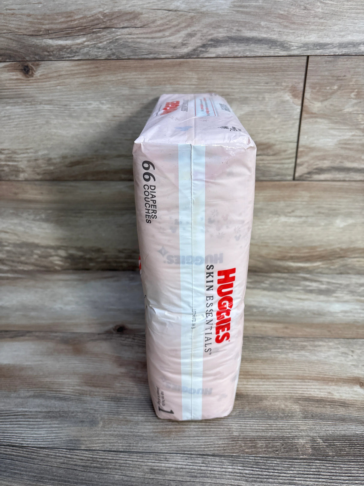 Huggies Skin Essentials 66 count diapers pack on wood floor