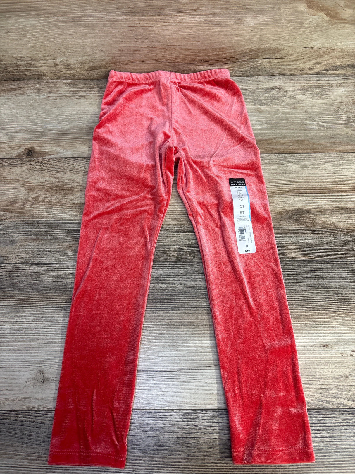 Pink velvet girls leggings size 5T with tag on wood floor