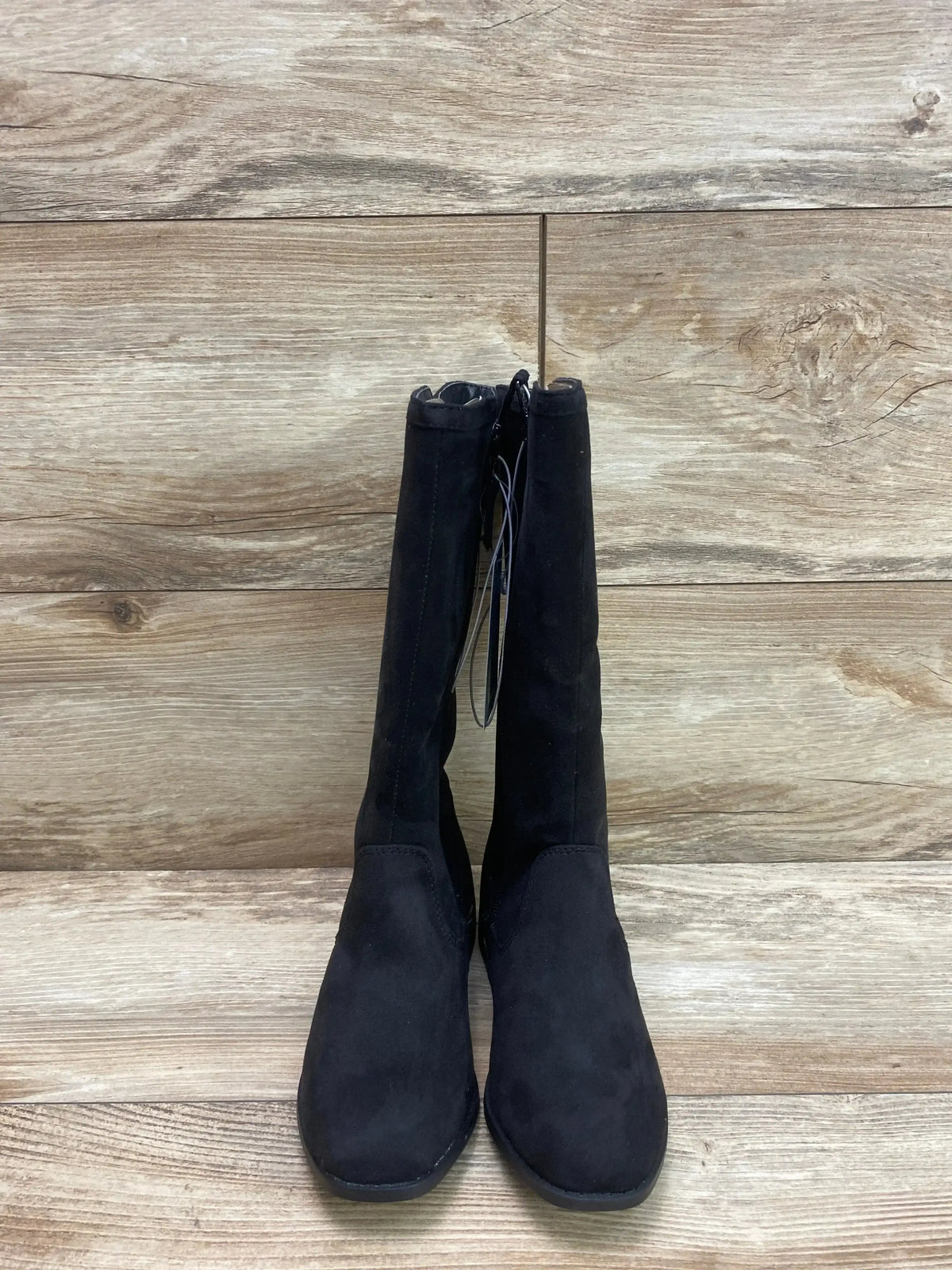 Front view of Cat and Jack Mylah tall riding boots showing black suede like material, round toe on wood plank background