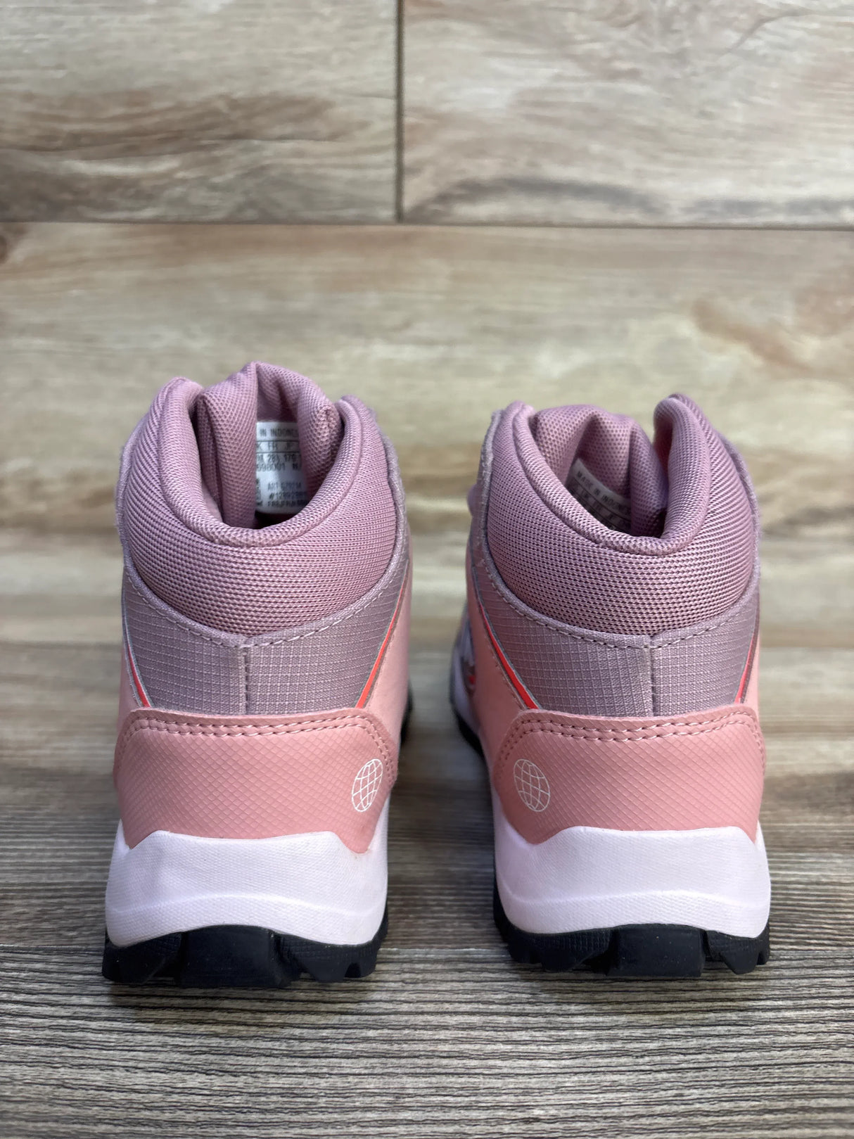 Rear view of Adidas TERREX Hyperhiker Mid sneakers in mauve size 11C showing padded collar and rugged tread on wood floor