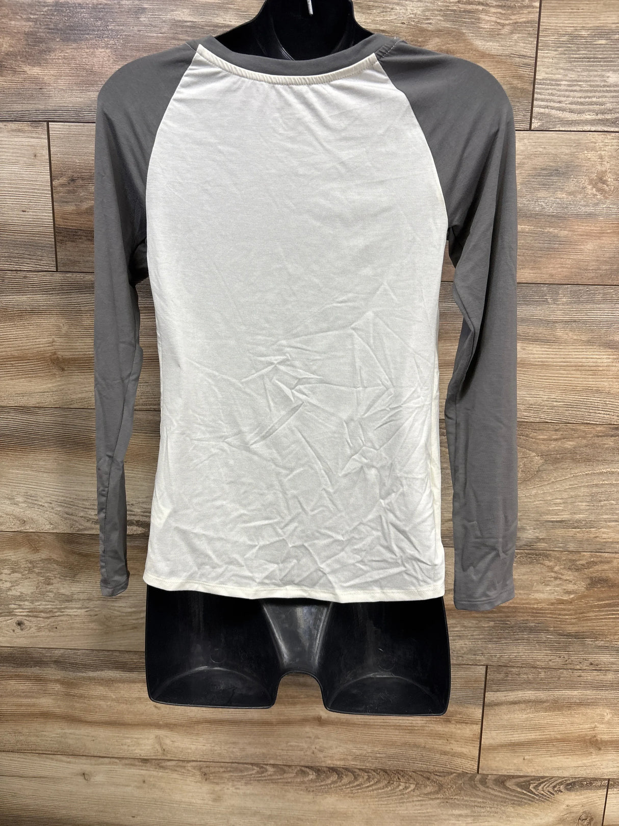 Gray and white raglan long sleeve shirt displayed on mannequin for kids or maternity wear