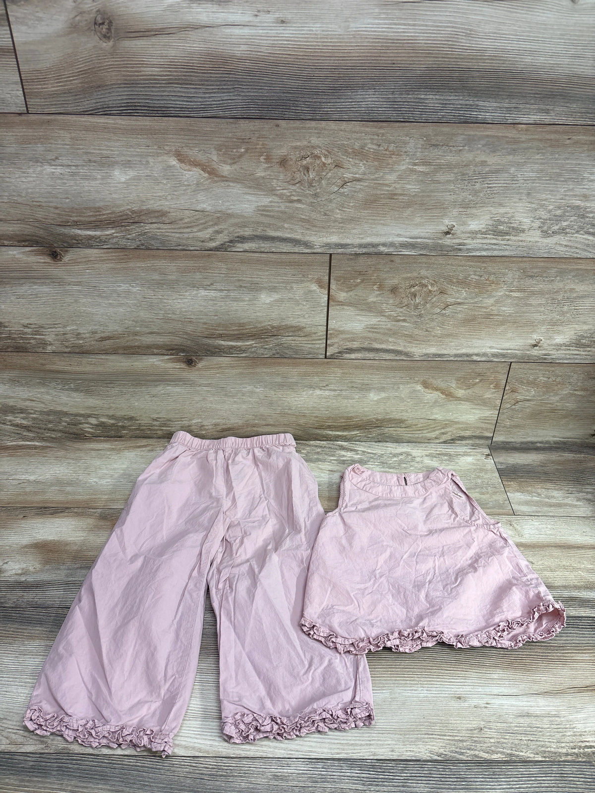 Zara pink 2-piece sleeveless top and ruffled pants set for girls size 5T on a wood background