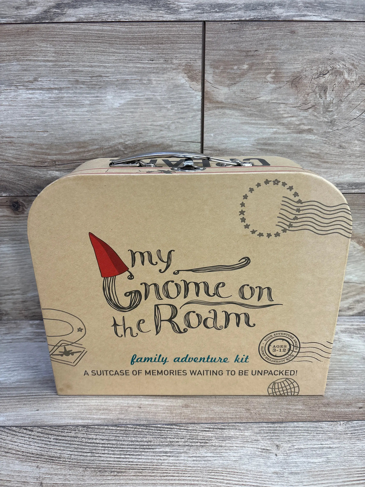 Front view of My Gnome On The Roam Adventure Kit suitcase featuring family adventure kit text on a wood look background