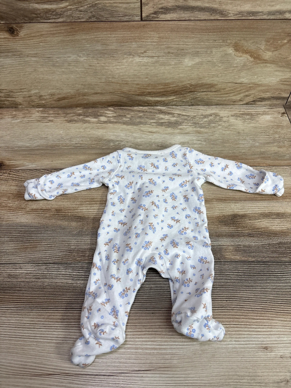 Child Of Mine white preemie sleeper with blue and brown floral print on wooden background