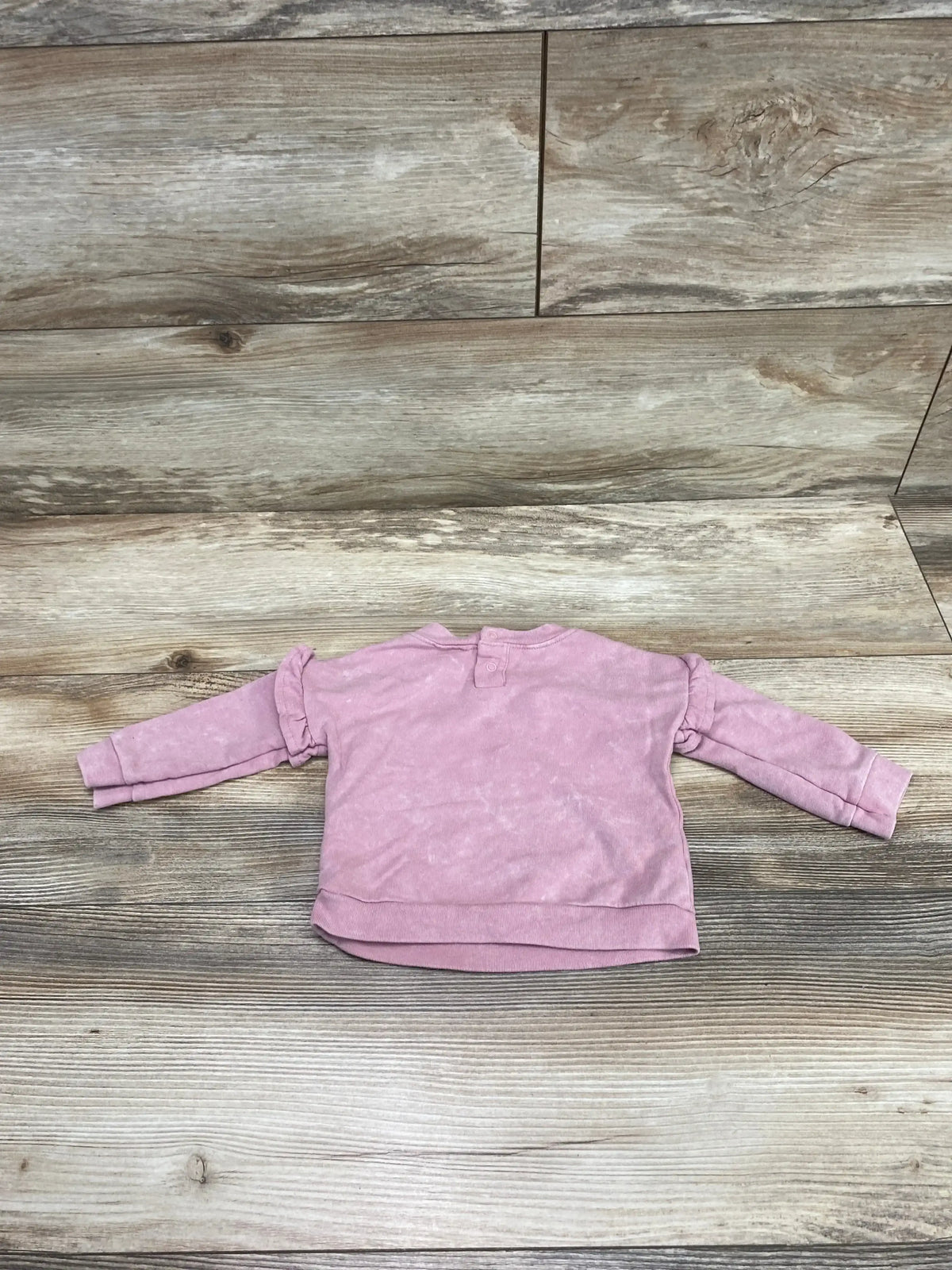 Front view of Cat & Jack pink baby sweatshirt size 0-3M showing crewneck, long sleeves, and ribbed cuffs on white background