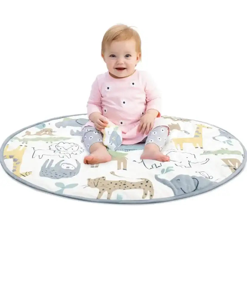 Front view of Carter’s Safari play gym mat showing round shape, gray trim, and safari animal print with baby seated on white background