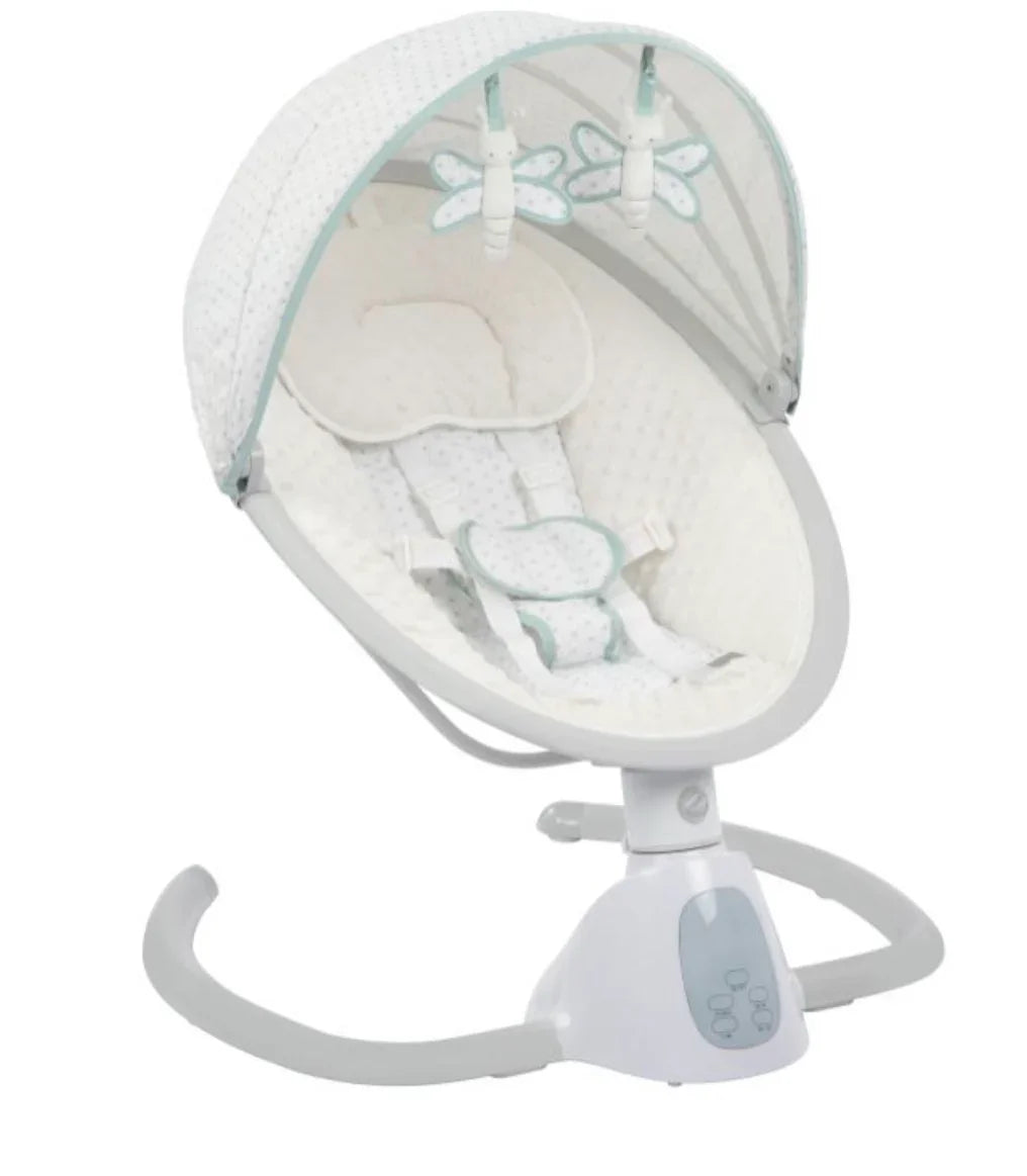 Angled view of Monbebe Tranquility swing with quilted cream seat, canopy with two hanging toys, harness and Bluetooth remote