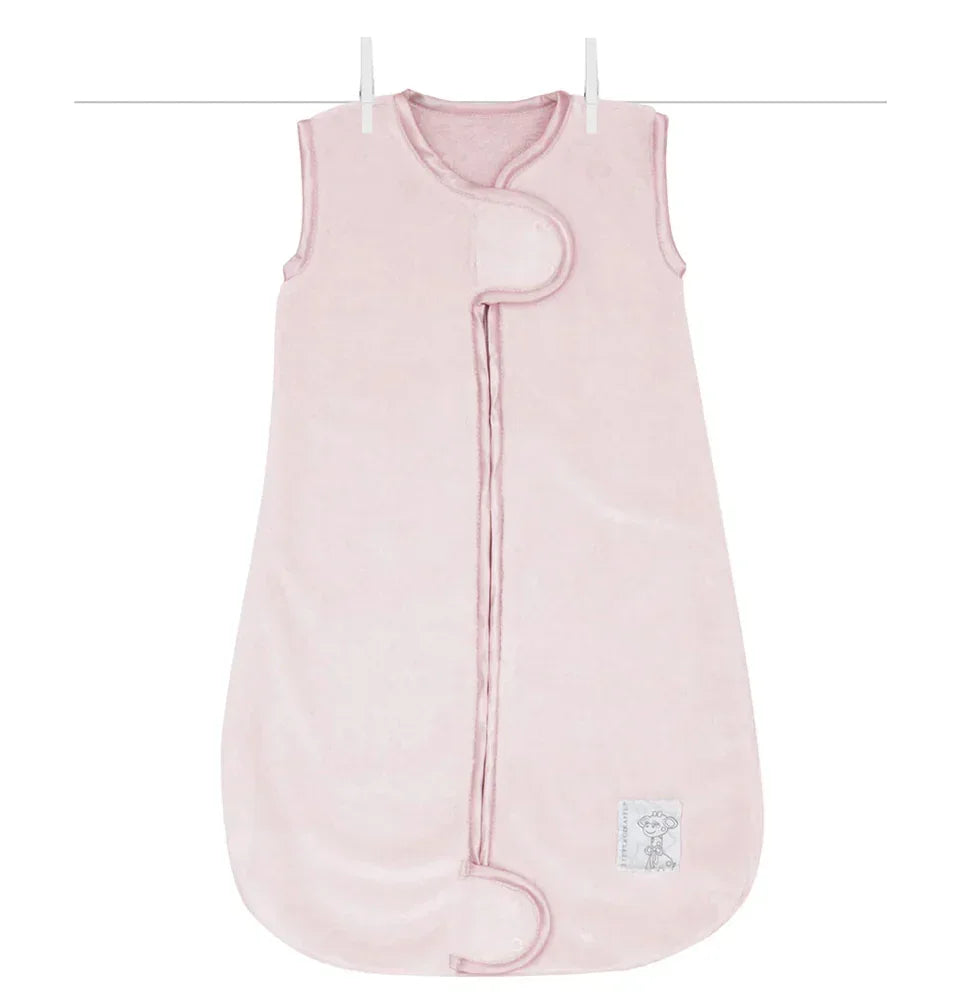 Light pink sleeveless baby sleep sack with front snap closure hanging on a line