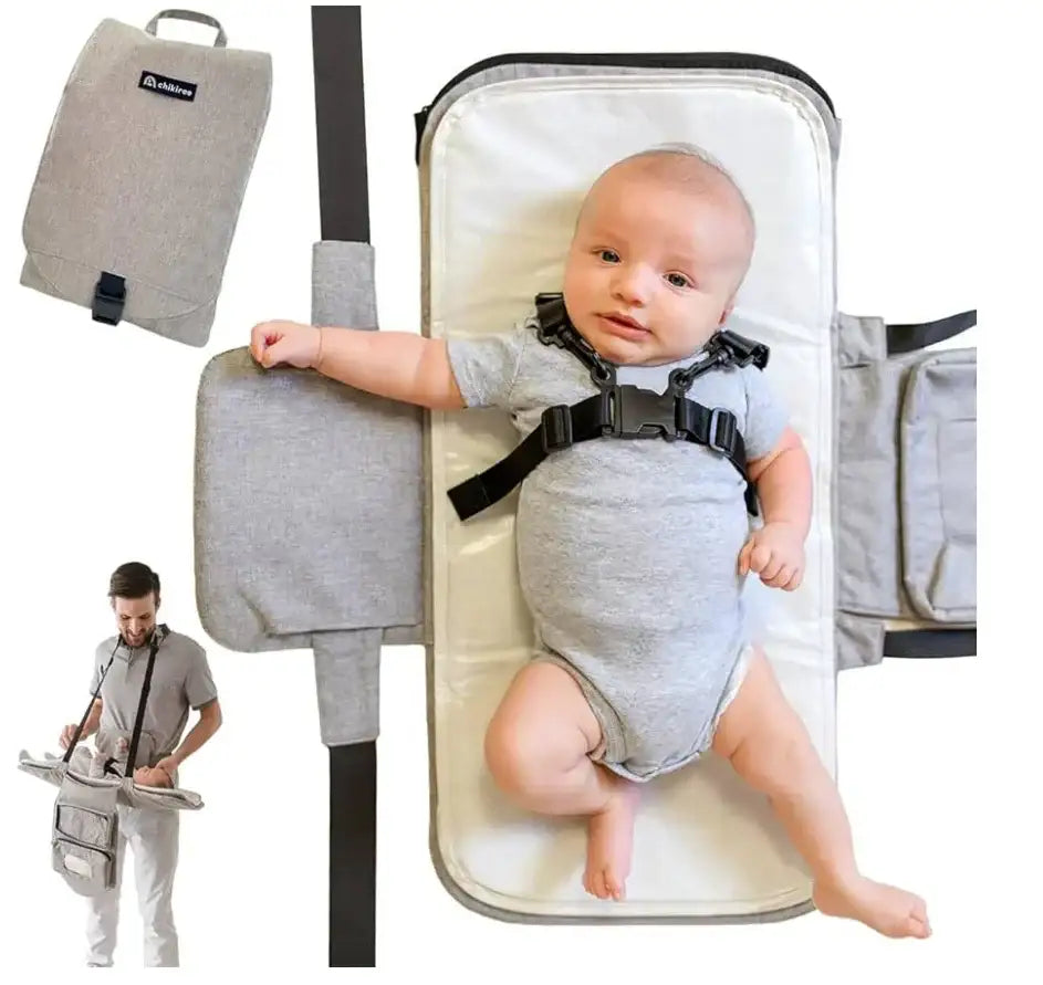 Chikiroo wearable changing station, top view: opened grey pad with baby in harness, folded case, crossbody strap shown