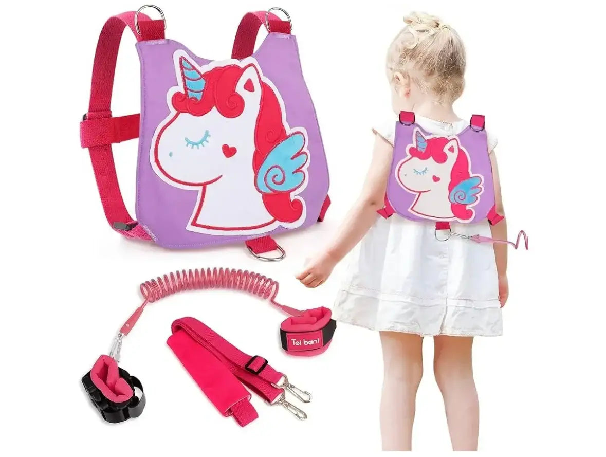 Toddler wearing a pink unicorn harness backpack with safety leash and anti-lost strap.