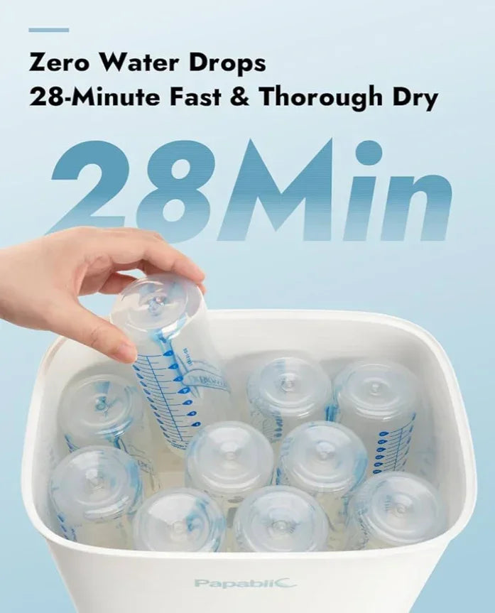 Hand placing baby bottle in Papablic sterilizer, fast bottle drying, 28-minute cycle